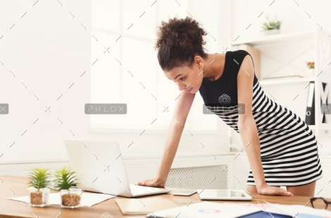 demo-attachment-115-business-woman-working-on-laptop-at-office-PRFJKQJ